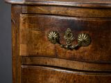 a wooden chest of drawers with brass knobs on it