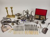 a lot of silverware on a table with a red box