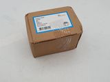 a brown box with a blue label sitting on a white surface