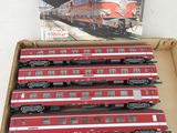 six red and white train cars in a box