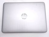 a laptop that is sitting on a white table