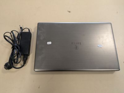 a laptop that is sitting on a table with a charger
