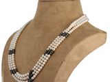 a close up of a necklace on a mannequin mannequin