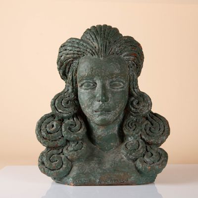 an image of a statue of a woman ' s head on a table