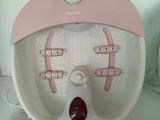 a pink and white electric foot spa machine on a table