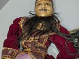 a statue of a man sitting on top of a table
