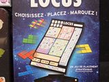 two books on the table with a board game in front of them
