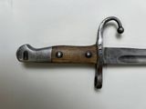 a knife that is hanging on a hook on the wall