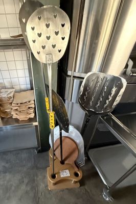 a lot of cooking utensils that are sitting on a stand