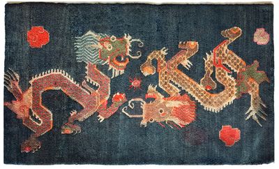 an oriental rug with a dragon design on a dark blue background