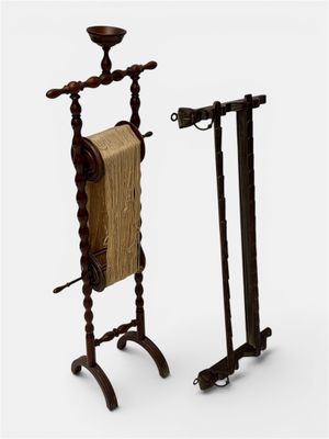 pair of antique wooden clothes racks with a towel rack on top