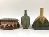 three vases sitting next to each other on a table