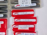 many different types of screws in a red box