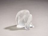 a glass elephant figurine sitting on a white surface