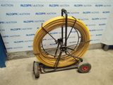 an image of a large yellow hose on a cart