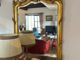 a table with a lamp and a mirror on top of it