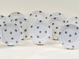 six plates with black and white designs on them on a white surface
