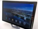 the tablet is being held up by a person holding it