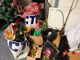 a pile of christmas decorations on the floor next to a christmas tree