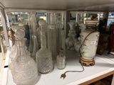de nombreux vases en verre posés sur une étagère dans un magasin