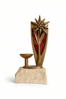 a statue of a vase and a candle on a stand
