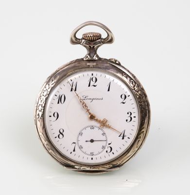 a silver pocket watch sitting on a white surface