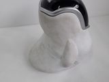 a silver and black object on a white surface
