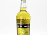 a bottle of chartreuse whisky sitting on a white surface