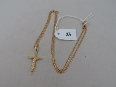 a close up of a cross and a chain on a table