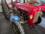 a red tractor that is parked in a garage