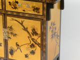 a small cabinet with a bird and flowers design on it