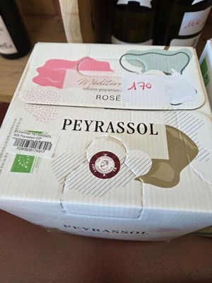 a box of wine sitting on a table next to a bottle of wine