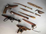 a lot of different types of weapons on the table