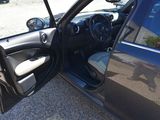 a black car with the door open and the driver ' s seat down