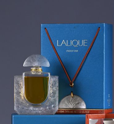 an assortment of perfumes and a box on a table
