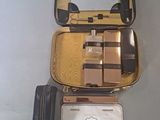 a suitcase with a mirror and a wallet on the table