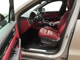 the interior of a car with the door open and the driver ' s seat up
