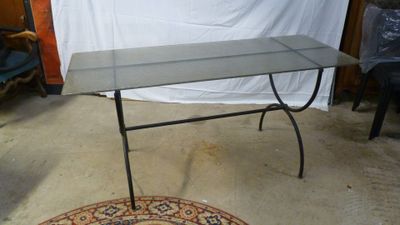 a table with a glass top on a rug in a room