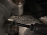 a close up of a metal object with a wren on it