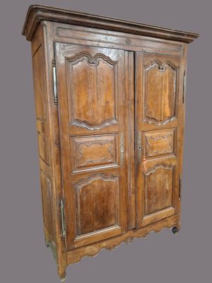 an old wooden armoire with two doors and two drawers
