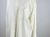 a white shirt on a mannequin stand with a white background