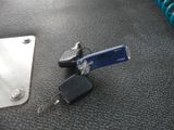 two keys and a keychain on the floor next to a padlock
