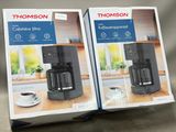 two boxes of coffee machines sitting on a table