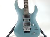 an electric guitar sitting on top of a stand on a white surface