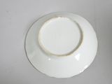 a white plate with a ring on it sitting on a table