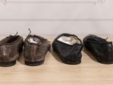 three pairs of shoes are lined up on a wooden table
