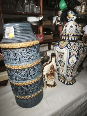 three vases sitting on a table in a room