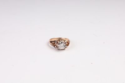 a close up of a diamond ring on a white surface