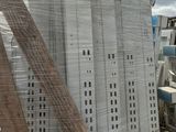 a large pile of white boxes on a pallet in a parking lot
