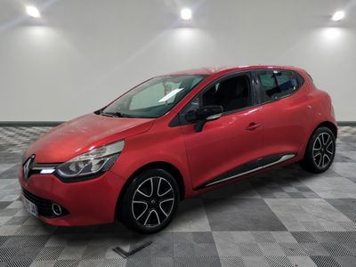 a red car parked on a checkered floor in a garage
